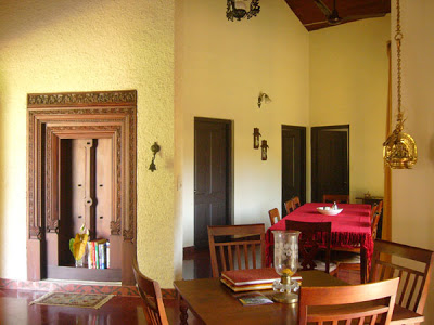 Gowri Nivas home stay | The dining area is decorated with hanging brass lamps, nooks and crannies, and a lovely old ornamental door