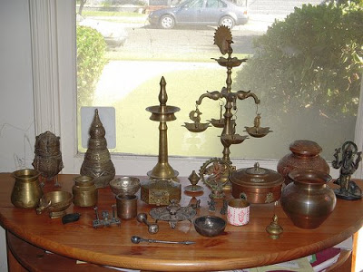 decorated the table with the collection of brass vessels or urns in indian style