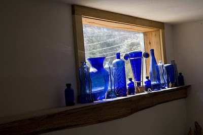 blue glass collection decorated on the window sill
