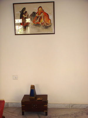 A painting hangs above the wooden chest