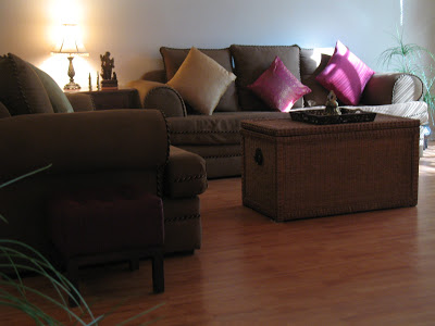 A wicker chest is used as a coffee table at the living room