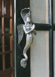 This bronze door handle of Naga Kannya