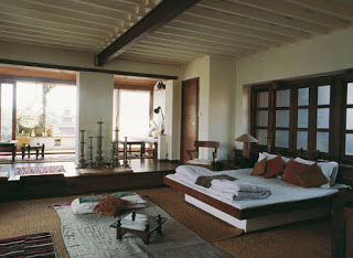 The elegant local style features low-level furnishings, Newari printed blankets, and a beaten copper bathroom