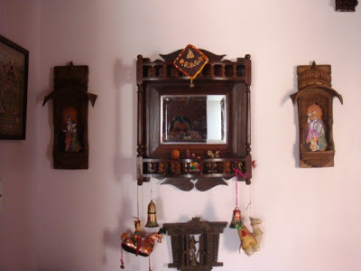 The antique mirror corner with wall dedicated to Krishna