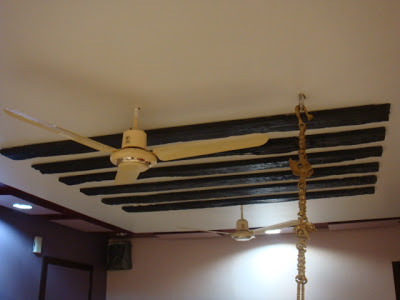 the living room roof is adorned with wooden rafters