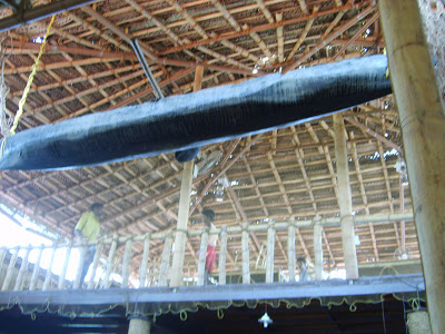 a local fishing boat hanging from the roof