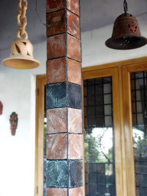 Handmade terracotta tiles in the sit out ordered from an NGO from Nilambur, Kerala