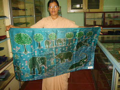 Sr. Prabha holding up a beautiful silk piece