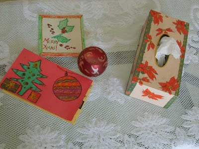 A completed poinsettia themed decoupage on a tissue box