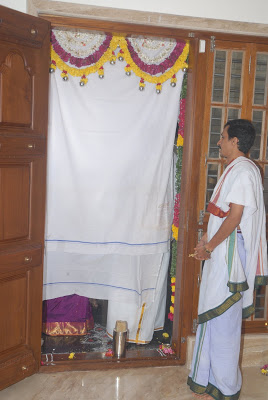 The priest covers the entrance and chants hymns before unveiling the covered entrance