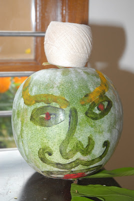 The decorated melon is filled with coins and color and crushed outside the house