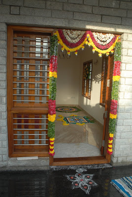 The house door is decorated with flowers and beautiful rangolis