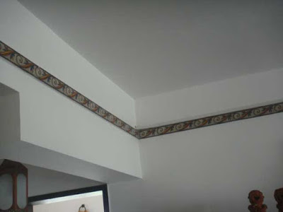 a lovely wall with a ceiling tile design