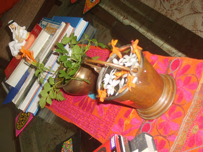 the collection of books, Arab and a bucket of flowers on tabletop
