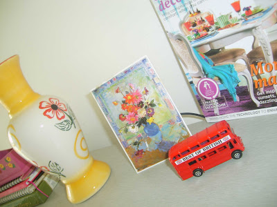 Yellow vase and knick-knacks at the corner on tabletop