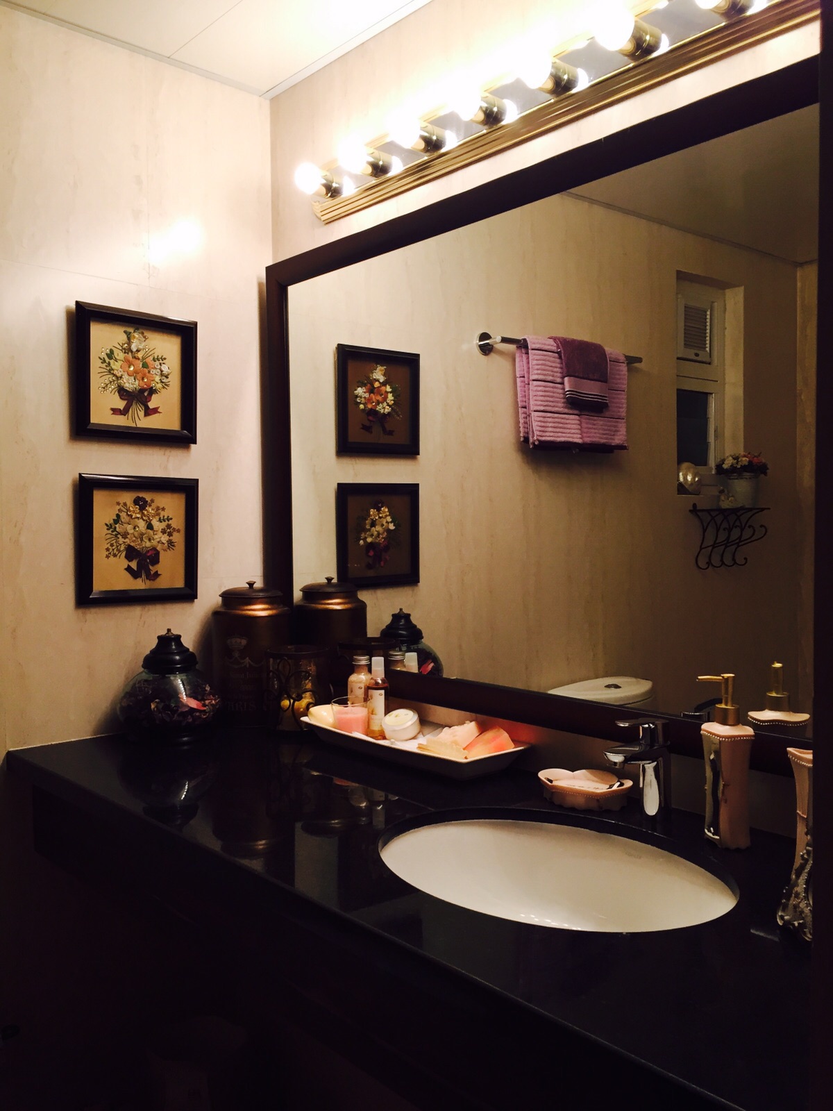 The wash and powder room is adjacent to the living room is designed with French accents too.