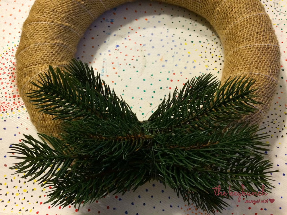 Wrap the straw wreath with burlap