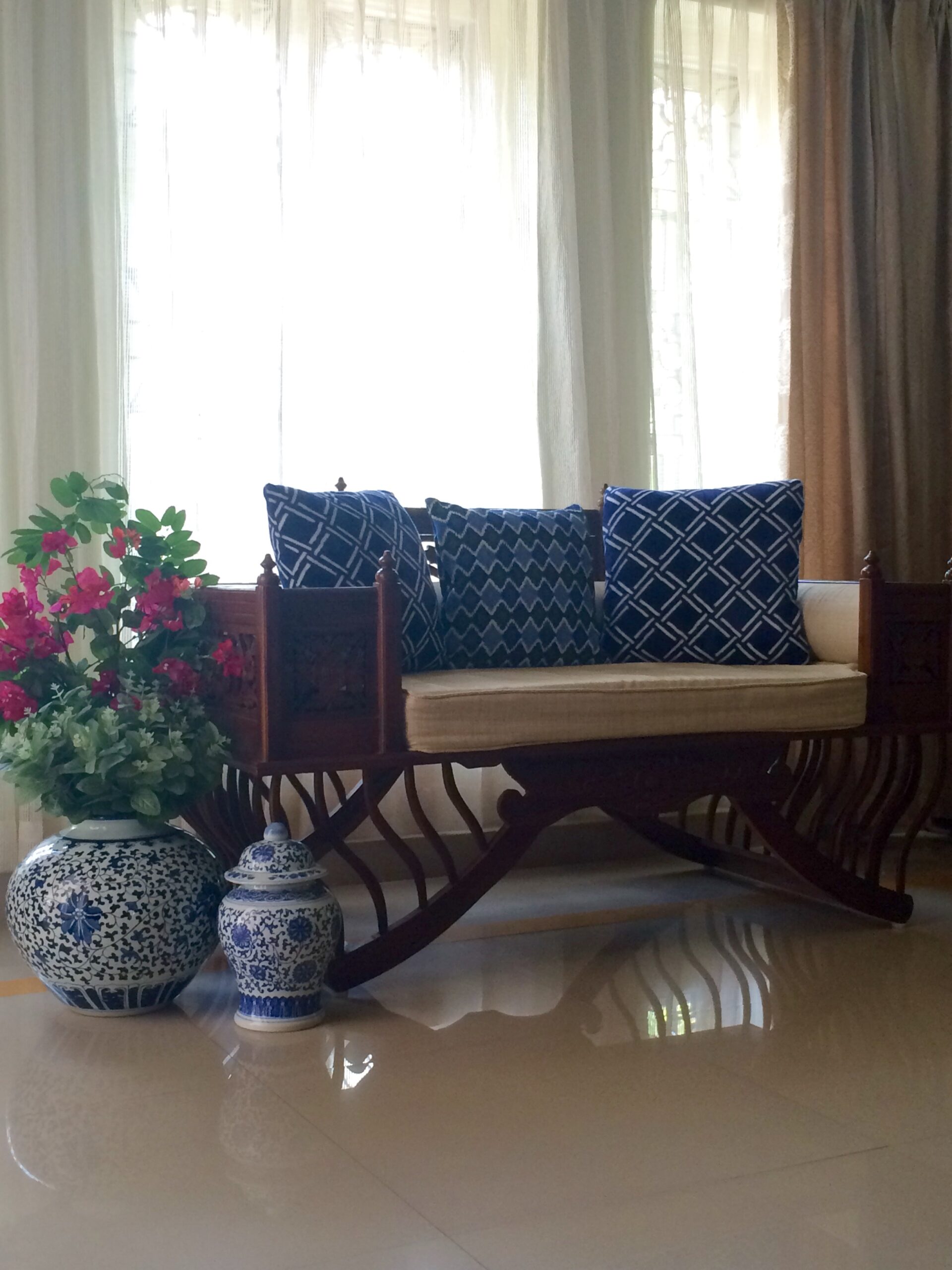 An elephant chair, jaipuri blue pottery and the pink bougainvillea add color to this foyer area | Joseph home tour
