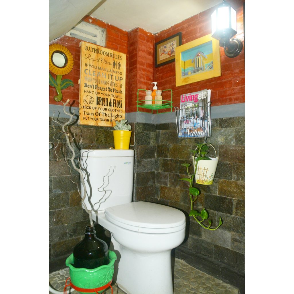 A tiny guest washroom on the first floor - a stylish and natural stone and brick wall finish | Inda and Sony Sulaksono's Colorful Home tour