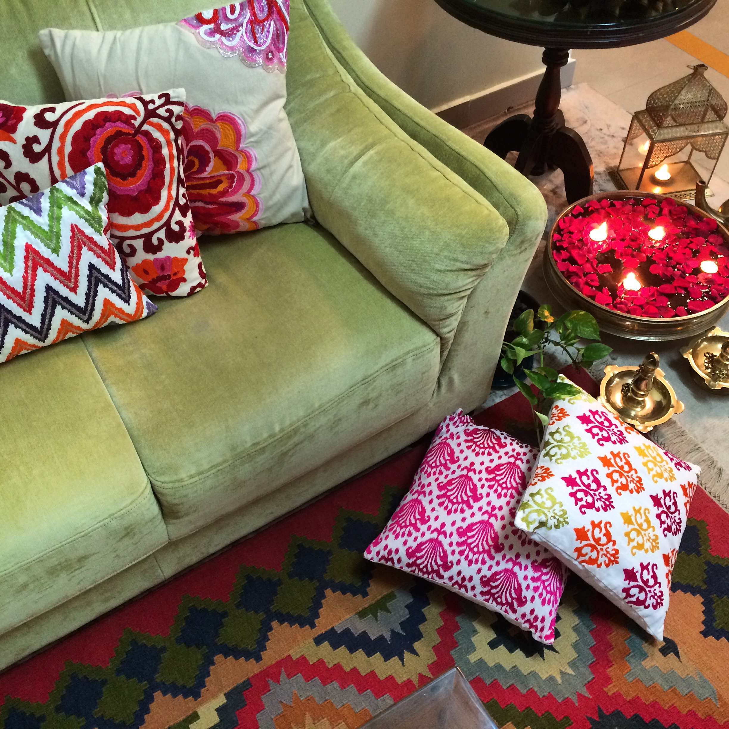 the living room with a colourful rug, brass Uruli and traditional oil lamps | Joseph home tour