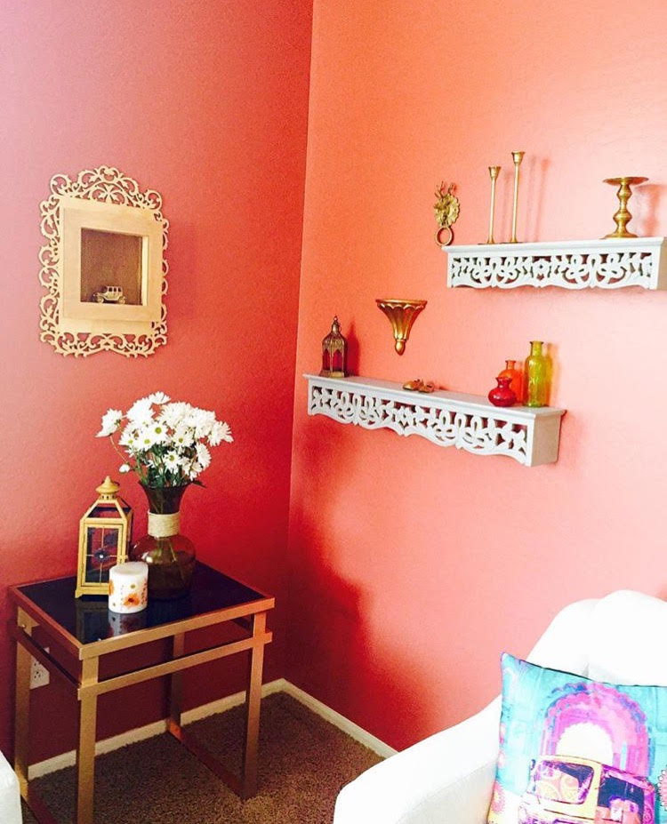 The beautiful carved wooden shelves and brass artifacts at wall living room | Ethnic-Global Style home in Arizona