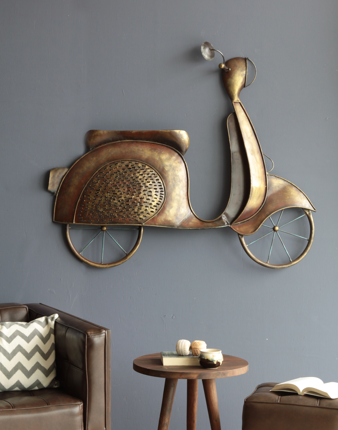 The classic style Scooty Wall Décor piece by Orange Tree is made out of iron and has an antique finish to it