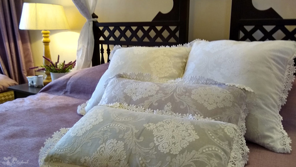 Jayashree Rajan's garden apartment tour on The Keybunch: bedroom with pillow cover and table lamp