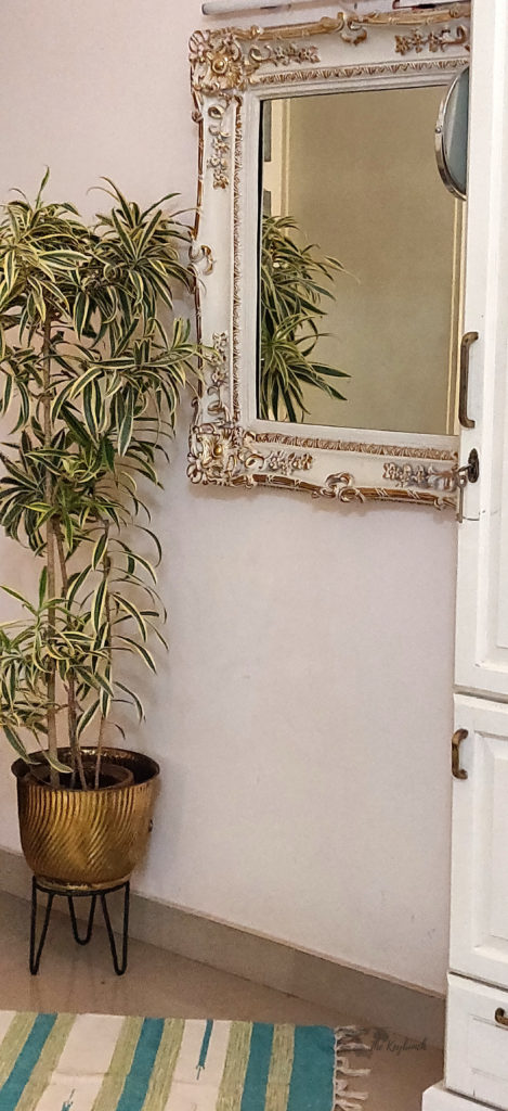 Jayashree Rajan's garden apartment tour on The Keybunch: A charming old mirror with gold embellishments