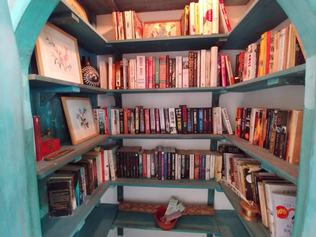 floor to cieling book shelves make this an interesting room to hang out in | Old church door makeover story
