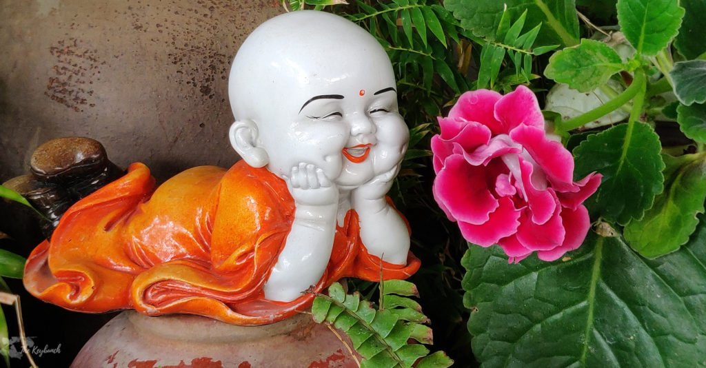 Jayashree Rajan's garden apartment tour on The Keybunch: buddha sculpture in green garden