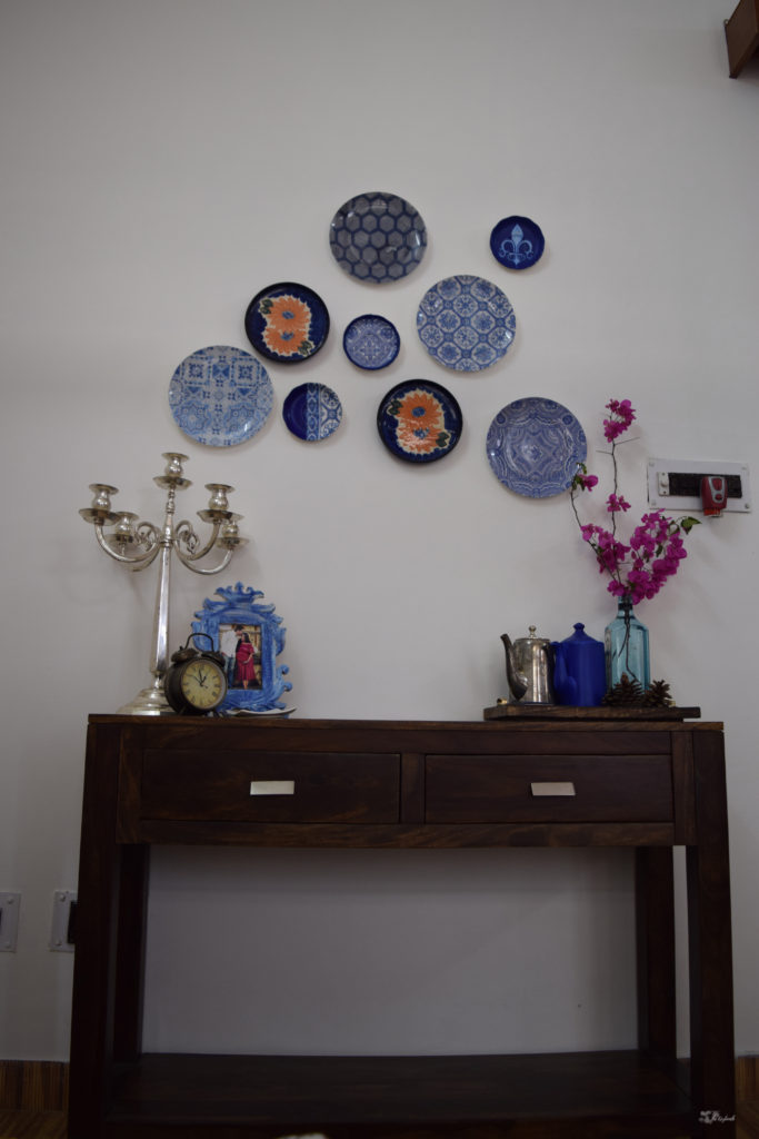 Home decor Tour by Ankita and Sitanshu’s in Lucknow - The bedroom are decorated with blue frame, candlebra, assorted jugs and wall plates