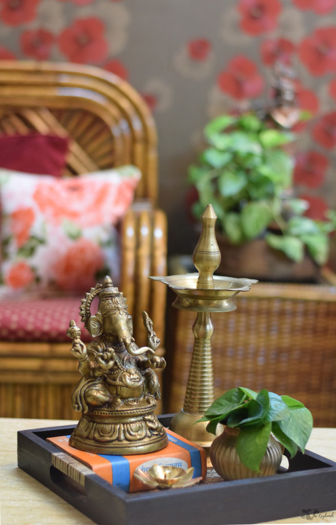 Home decor Tour by Ankita and Sitanshu’s in Lucknow - brass collection and green plants at living room