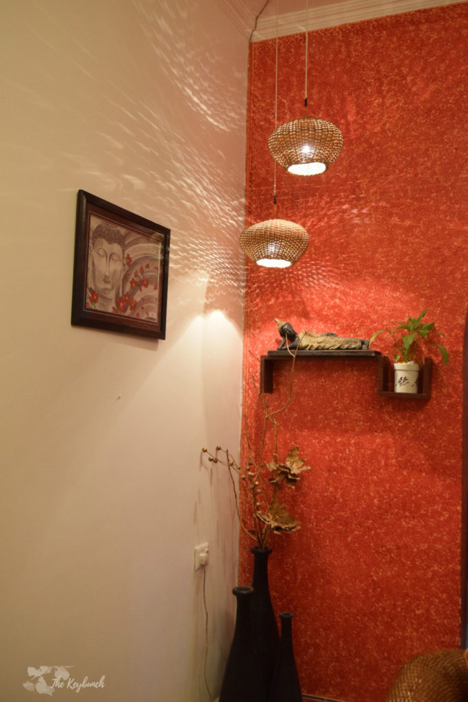 Home decor Tour by Ankita and Sitanshu’s in Lucknow - the orange accent wall shelves adorned with plants and artifacts