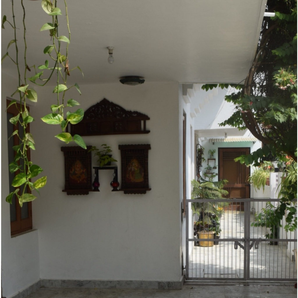 Home decor Tour by Ankita and Sitanshu’s in Lucknow - headboard from old bed on the wall with green plants