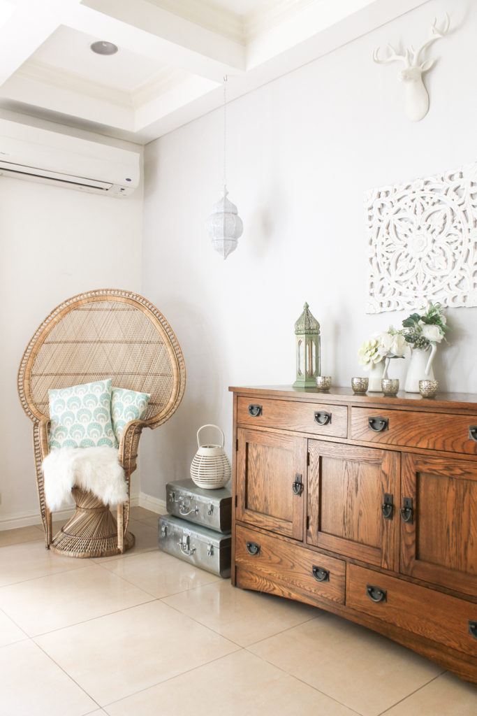 Home Tour with Kaho of Chuzai Living - the living room filled with rattan chair, desk chest, trunk, lamp and vintages