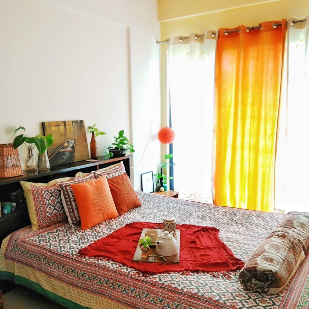 Jayati and Manali share their home tour as the science home décor - the headboard space fill with lamp, frame and green plants