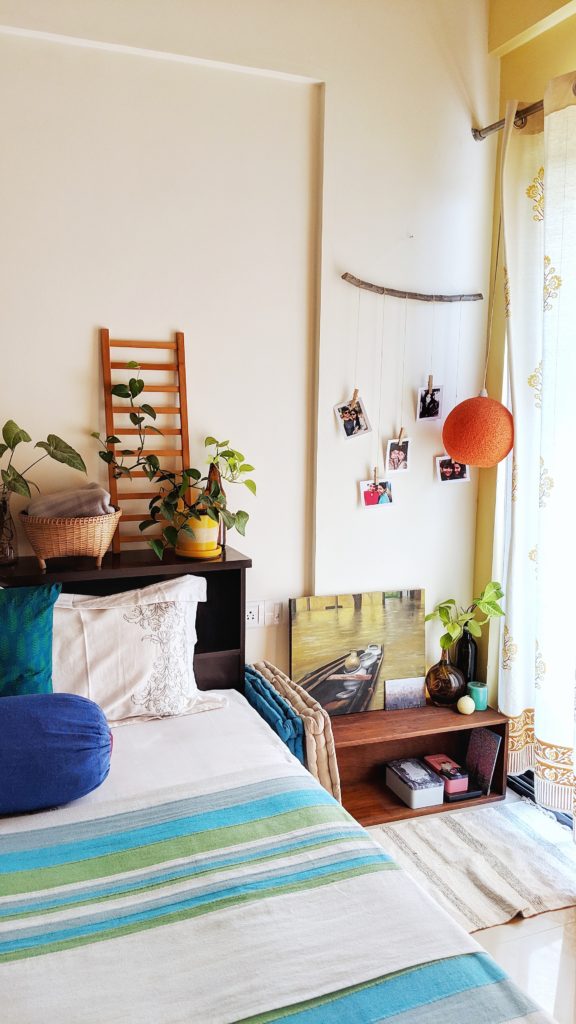 Jayati and Manali share their home tour as the science home décor - the bedroom is decorated with beautiful photos, hanging light, green plants, ladder and handpainted frame