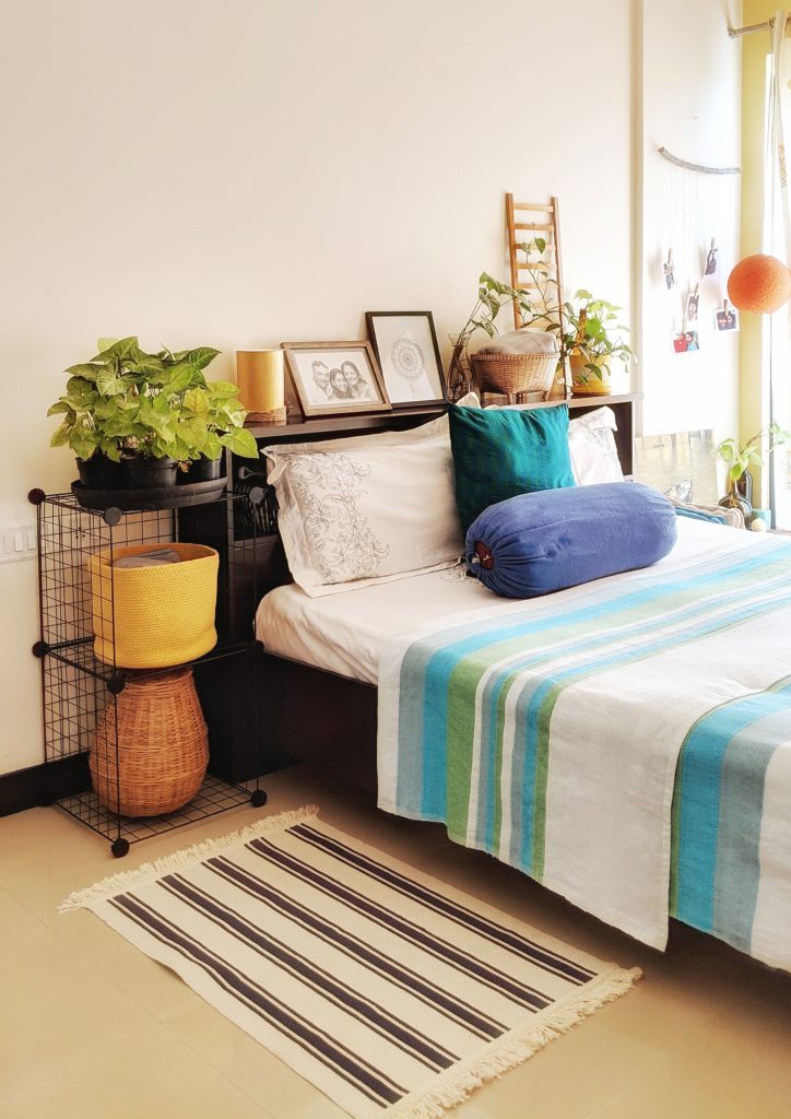 Jayati and Manali share their home tour as the science home décor - the headboard space fill with lamp, ladder, frame mandala and green plants