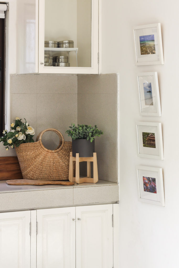 Home Tour with Kaho of Chuzai Living - A corner of the kitchen cabinet filled with basket, green plants and wall frames