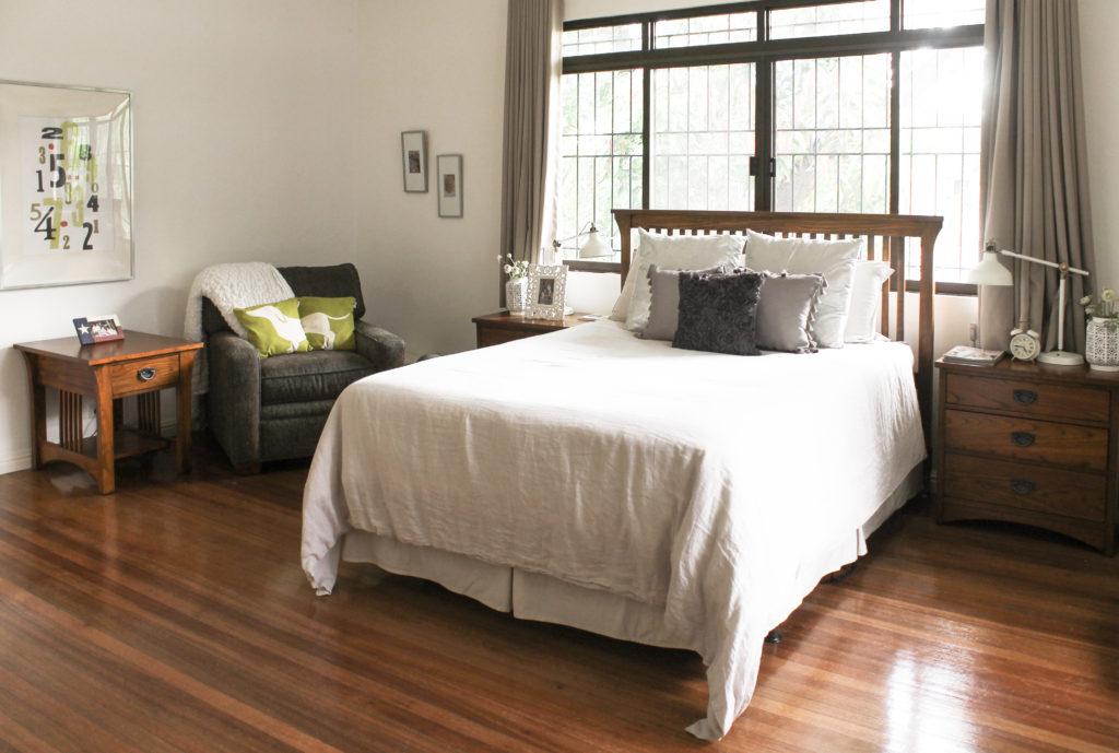 Home Tour with Kaho of Chuzai Living - the master bedroom filled with photo frame, sofa chair, table and table lamp