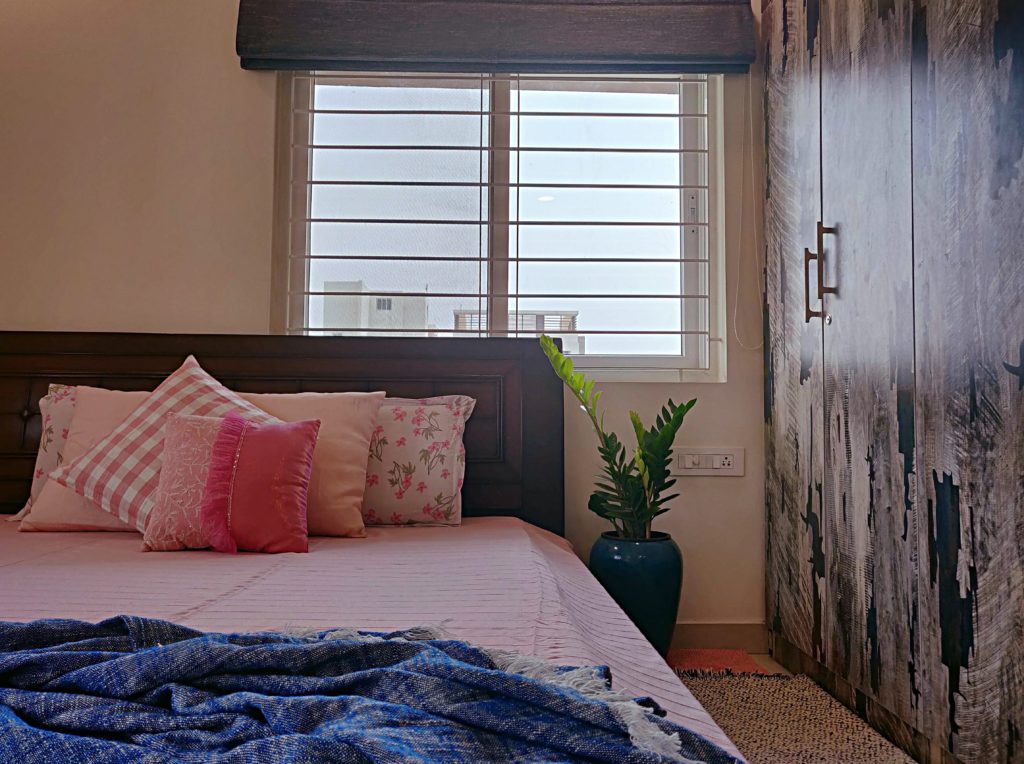 Home style Tour with Rajni in Hyderabad: the collection of pink cushion and green plants make the bedroom simple and beautiful