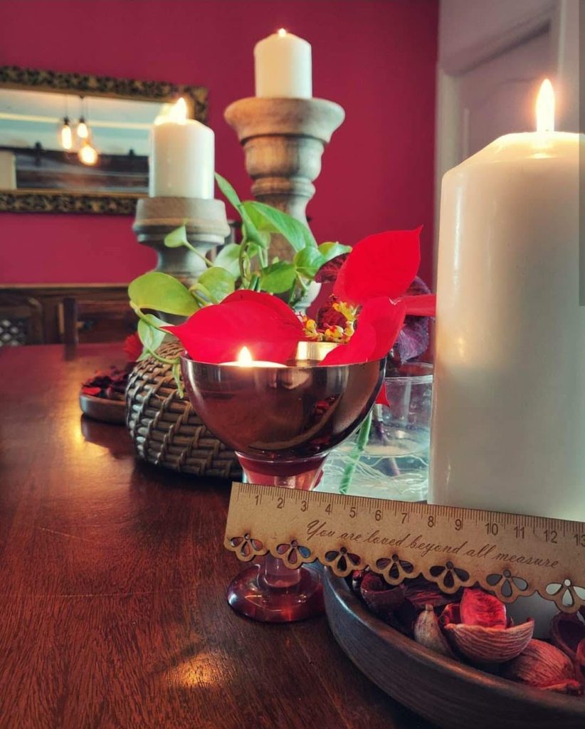 Home style Tour with Rajni in Hyderabad: the side table is decorated with some candles in nice candle holders/votives some fresh flower arrangements in vase or just petals in a copper bowl