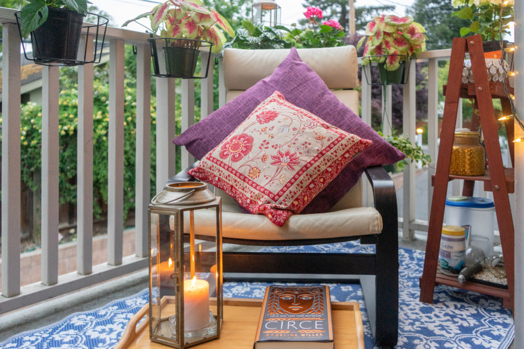 Affinity for antiques and collection of vintage | Home tour of Rushika & Dipkal's - The chair, candle stand, and book helps to cozify the space, and the hanging planters add extra planting area