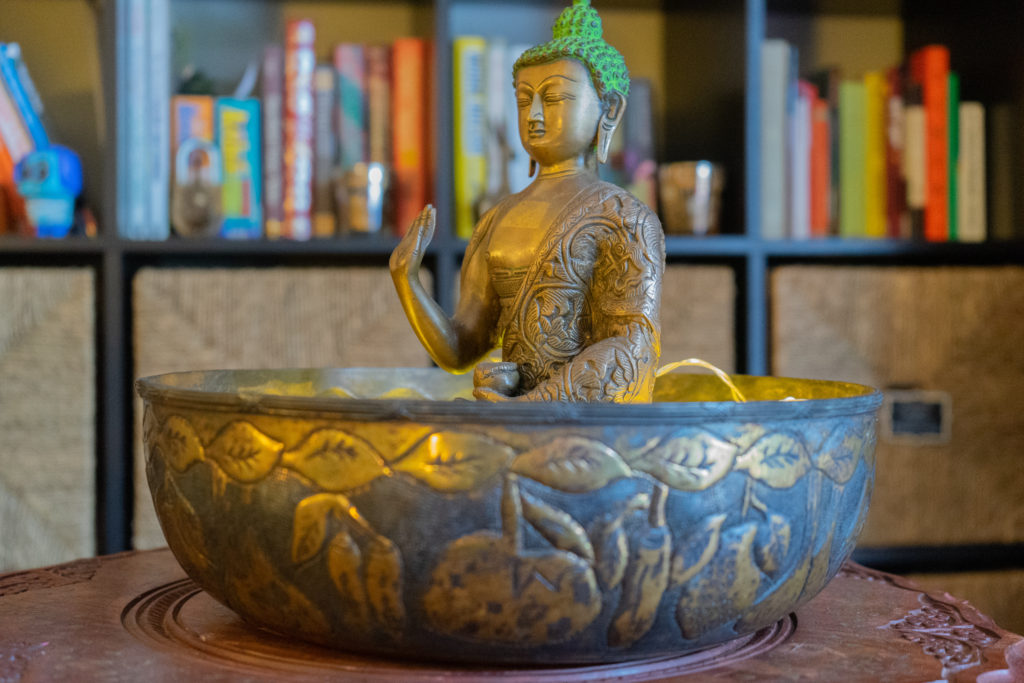 Affinity for antiques and collection of vintage | Home tour of Rushika & Dipkal's - the brass buddha at the corner of the living room