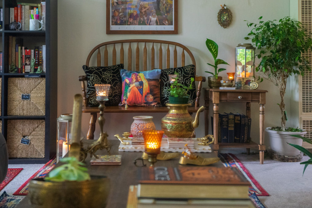 Affinity for antiques and collection of vintage | Home tour of Rushika & Dipkal's - the beautiful collection of brass decor, candle stands, lanterns and oil painting at the sitting room