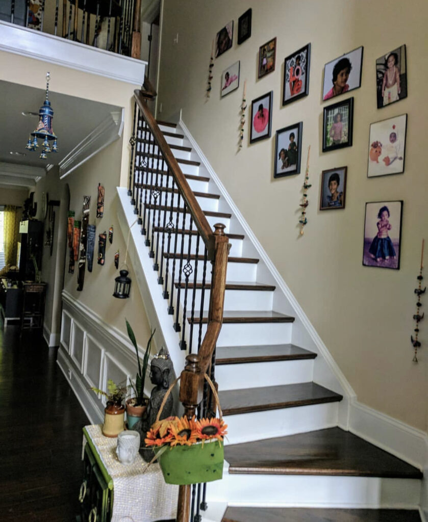 The staircase is decorated with photo gallery on the wall