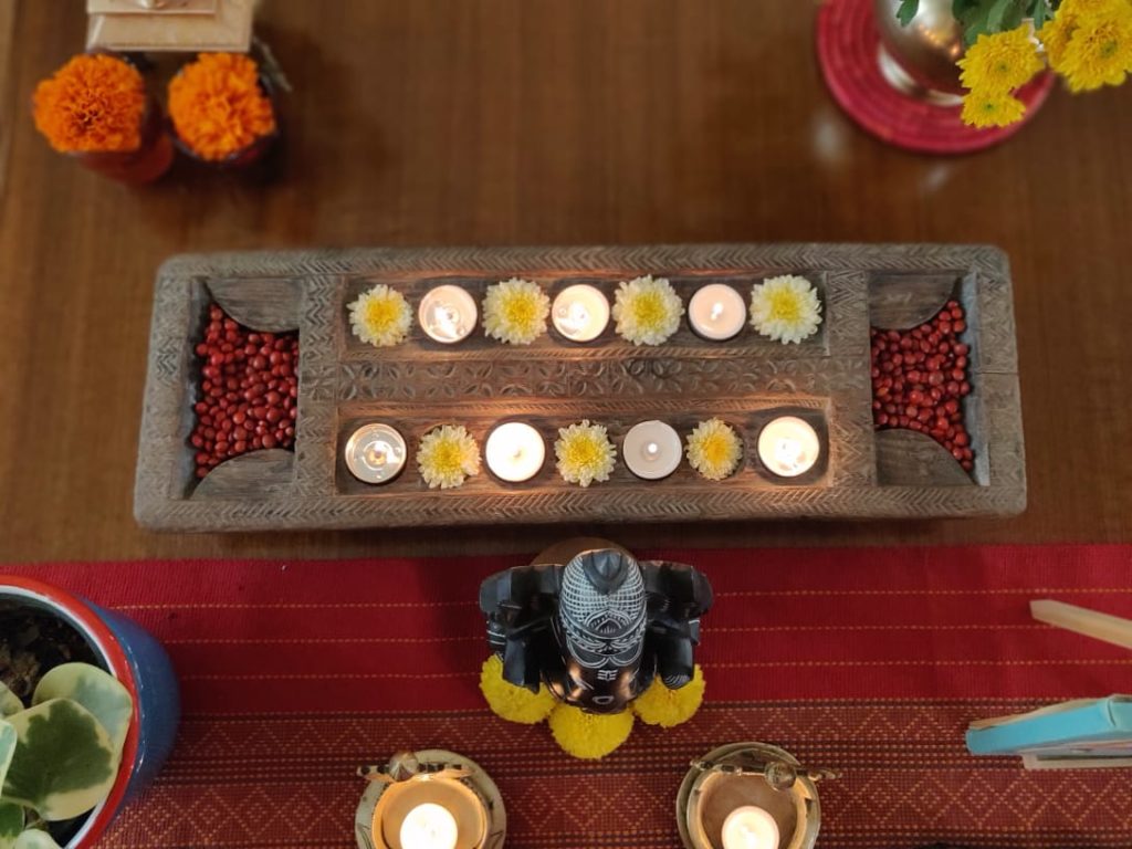 Wooden diya stand for diwali decoration at the living room table