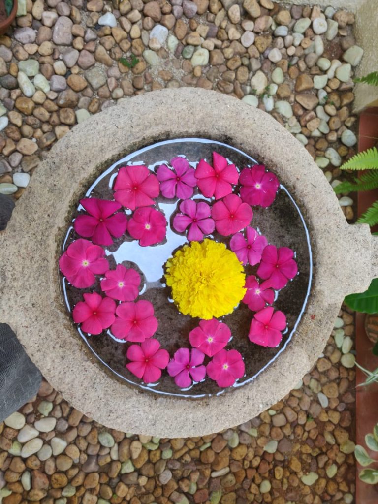 Fresh flower rangoli at the corner of the garden