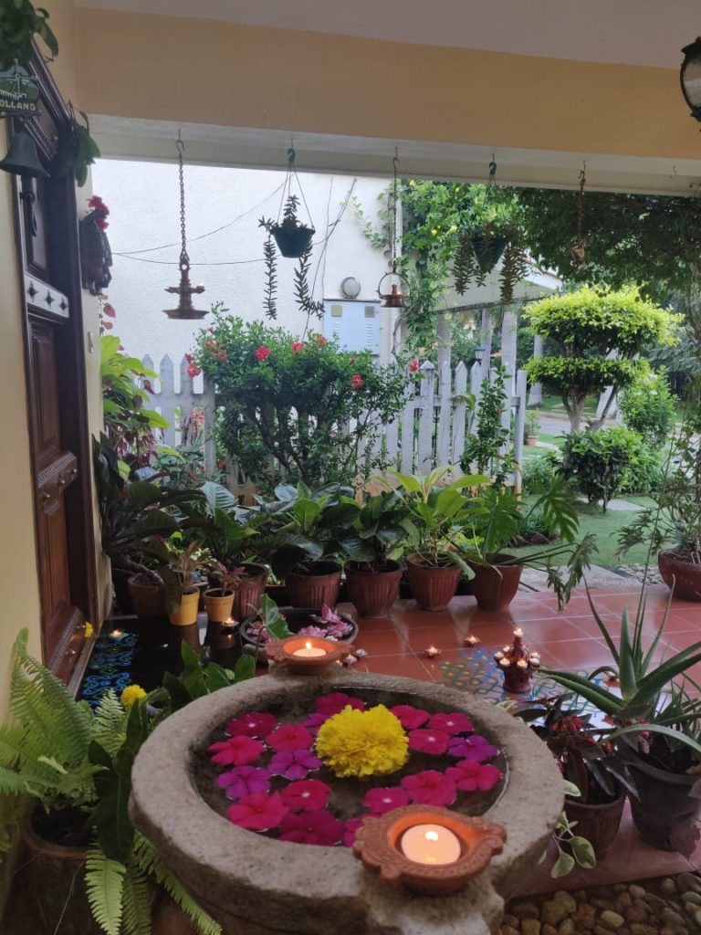 the front door entry is decorated with rangoli and surrounded by diyas for diwali festival celebration