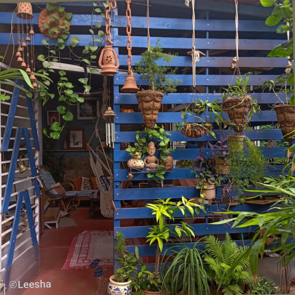 The assortment of lamps and terracotta bells at a blue slatted structure | Leesha's Pune home tour | Thekeybunch